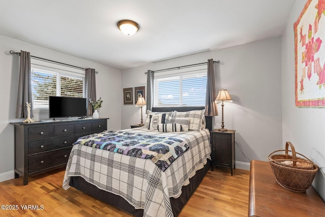 bedroom with baseboards and light wood-style floors