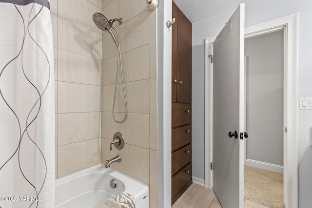 full bathroom featuring baseboards and shower / bath combination with curtain