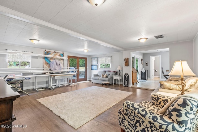 living room featuring visible vents and wood finished floors