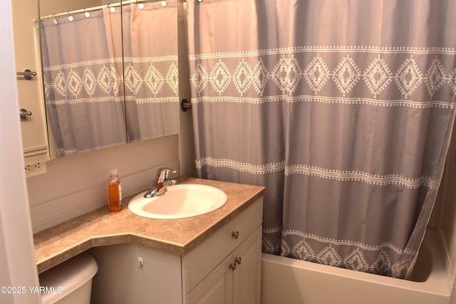 bathroom featuring vanity, shower / bath combination with curtain, and toilet