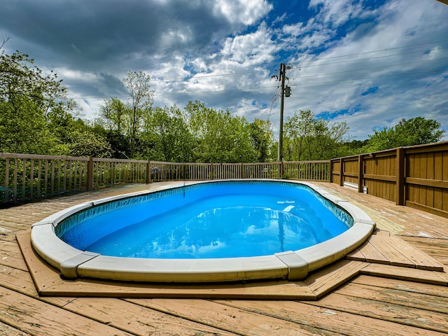 view of swimming pool with a deck