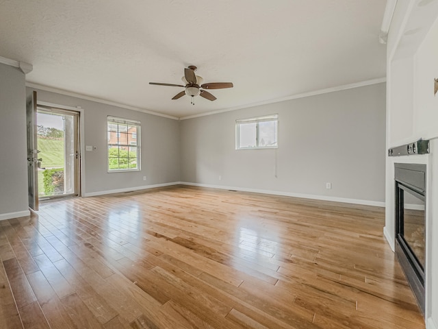 unfurnished living room featuring crown molding, ceiling fan, a textured ceiling, and light wood-type flooring