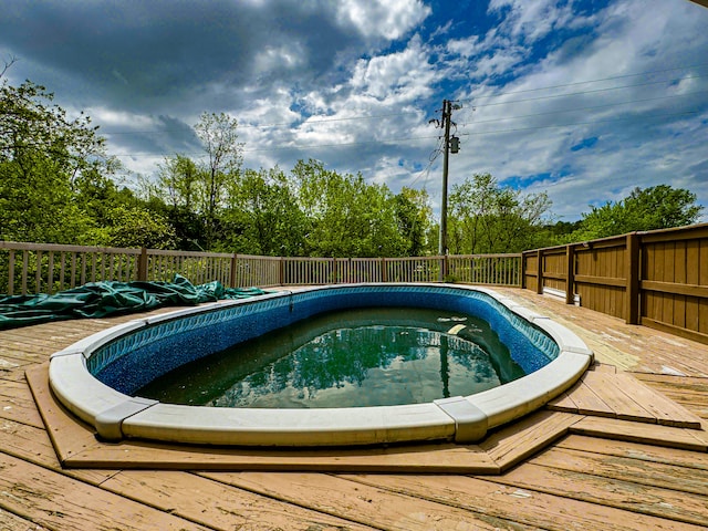 view of pool featuring a wooden deck and a hot tub