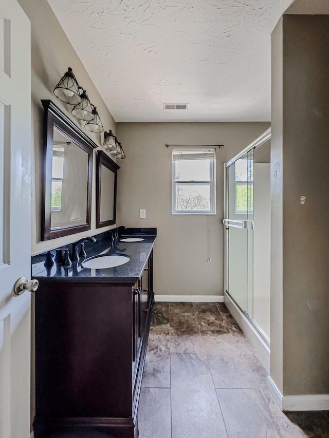 bathroom with walk in shower, vanity, and tile floors