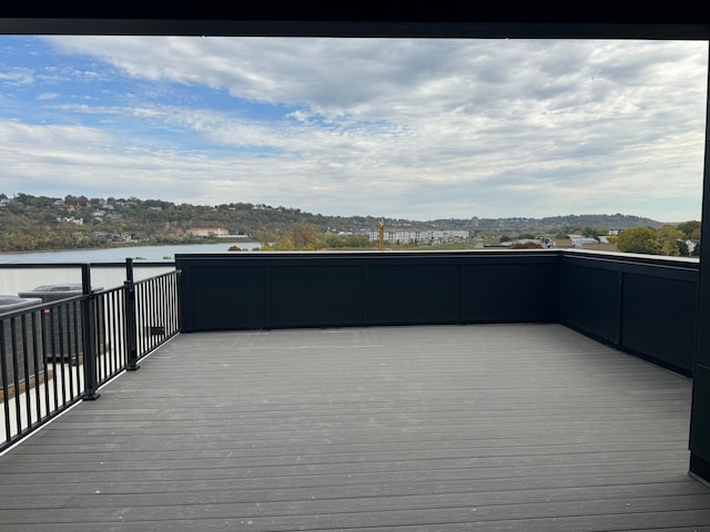 wooden terrace featuring a water view