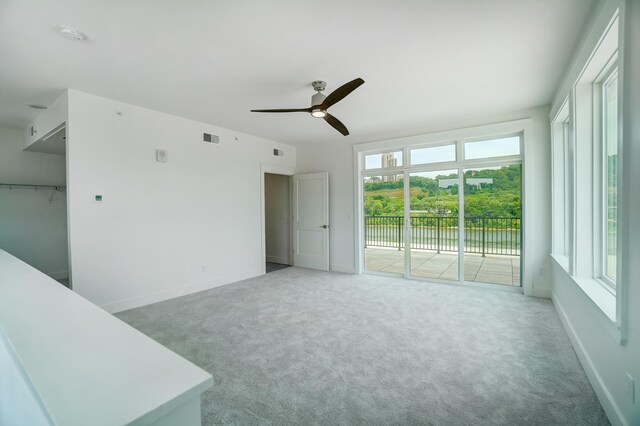 empty room with carpet flooring and ceiling fan