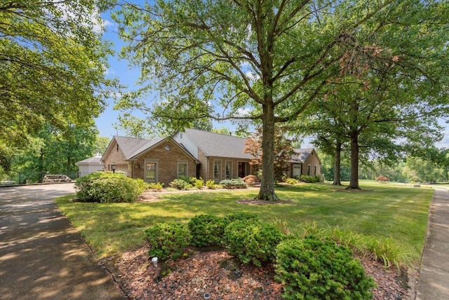 view of front of house featuring a garage and a front lawn