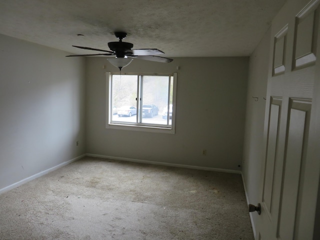 spare room featuring a ceiling fan, a textured ceiling, baseboards, and carpet flooring