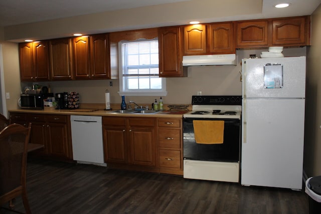 kitchen featuring white appliances, dark hardwood / wood-style flooring, and sink