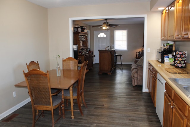 dining room with dark hardwood / wood-style flooring and ceiling fan