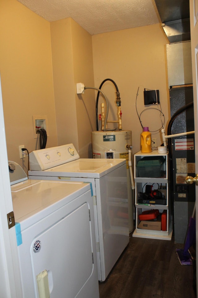 clothes washing area featuring separate washer and dryer, a textured ceiling, and dark wood-type flooring