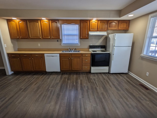 kitchen with sink, dark hardwood / wood-style flooring, and white appliances