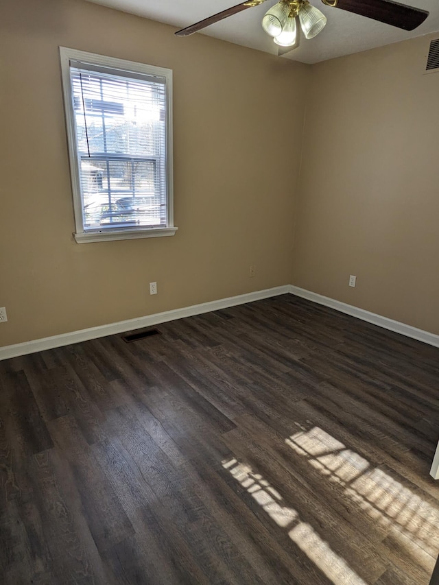 spare room featuring dark hardwood / wood-style flooring and ceiling fan