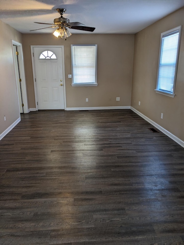 entryway featuring ceiling fan and dark wood-type flooring