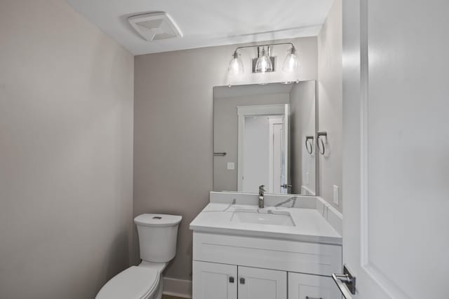 bathroom with toilet and vanity