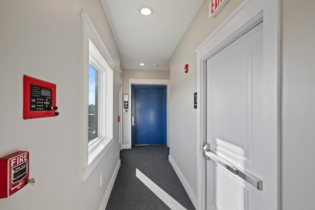 hall with plenty of natural light and elevator