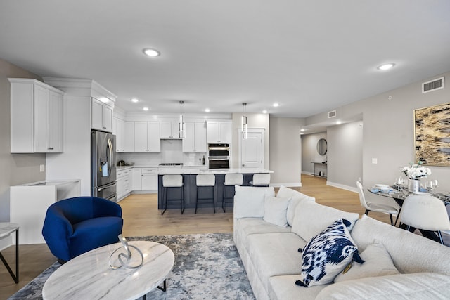 living room with light hardwood / wood-style flooring