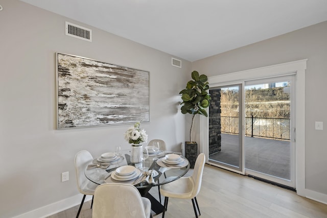 dining space with light hardwood / wood-style flooring