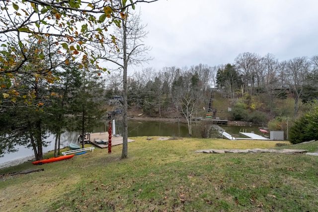 view of yard featuring a water view and a dock