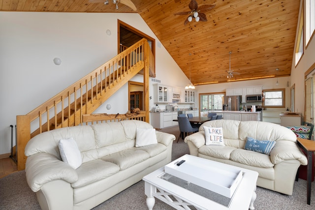 carpeted living room featuring ceiling fan, high vaulted ceiling, and wooden ceiling