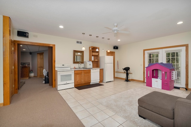 kitchen featuring white appliances, ceiling fan, sink, light tile patterned floors, and hanging light fixtures