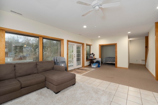 living room with ceiling fan, light colored carpet, and french doors