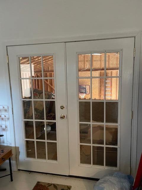 doorway with french doors and a healthy amount of sunlight