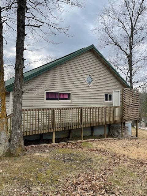 view of side of home with a deck