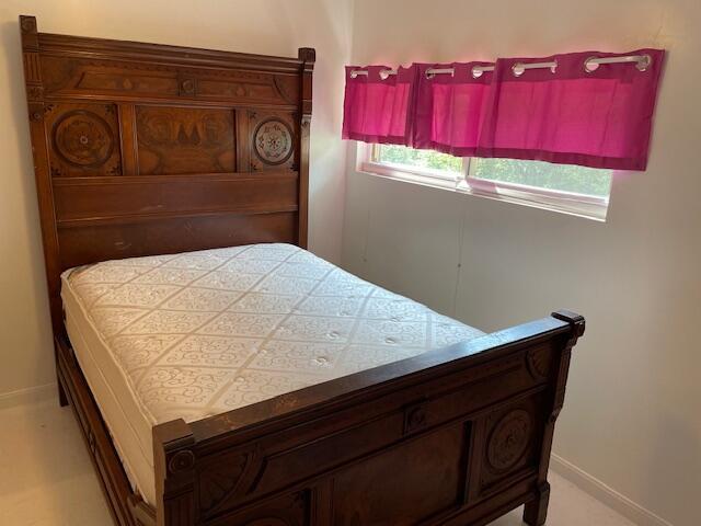 bedroom featuring baseboards