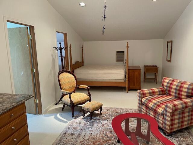 carpeted bedroom featuring recessed lighting, a wall mounted AC, and vaulted ceiling