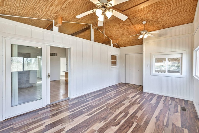 unfurnished room featuring a wealth of natural light, dark hardwood / wood-style floors, ceiling fan, and wooden ceiling