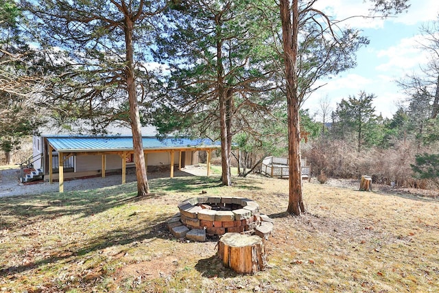 view of yard with a storage unit and an outdoor fire pit