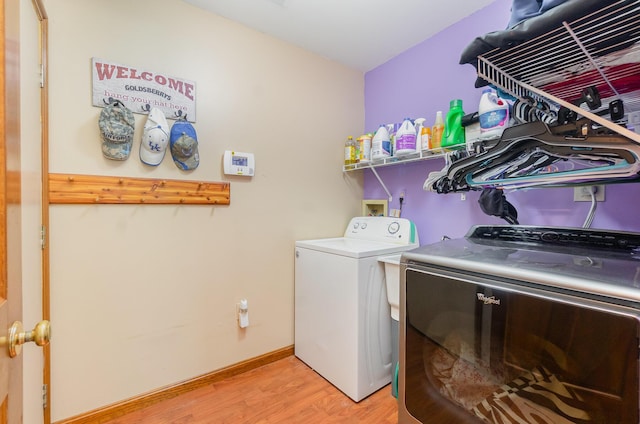 8104 Harms Hill Dr, Florence, KY 41042 - washroom featuring separate washer and dryer, light wood-style floors, and baseboards