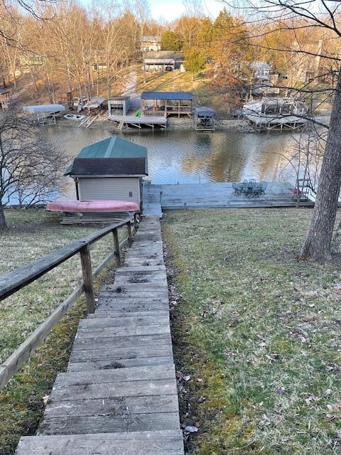 dock area featuring a water view and a yard