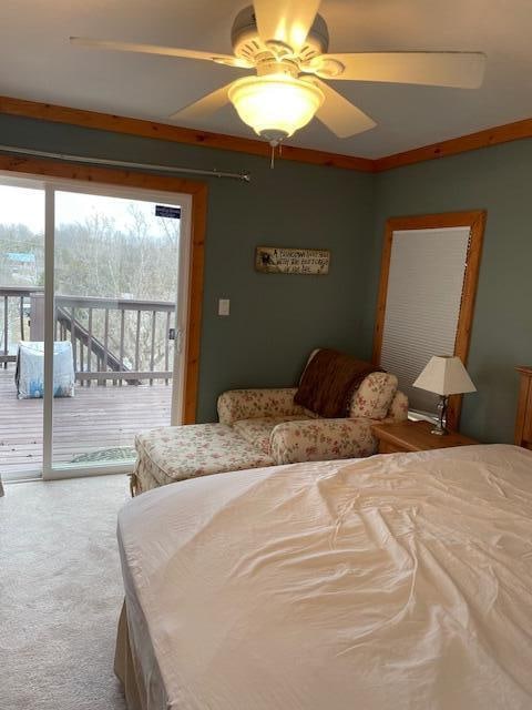 carpeted bedroom with ceiling fan, ornamental molding, and access to outside