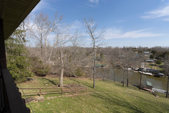 view of yard featuring a water view and a dock