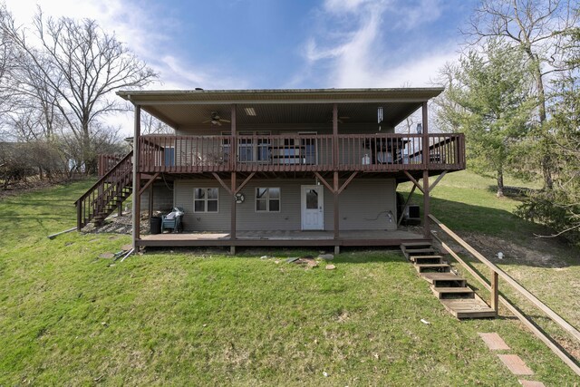 back of property featuring a wooden deck and a yard