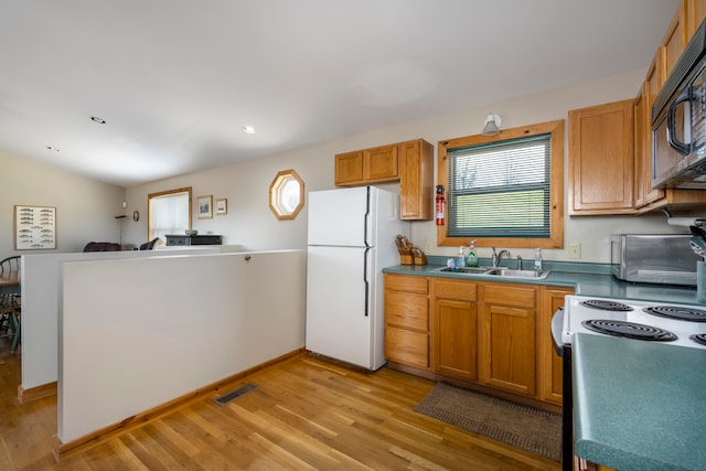 kitchen with white appliances, sink, and light hardwood / wood-style floors