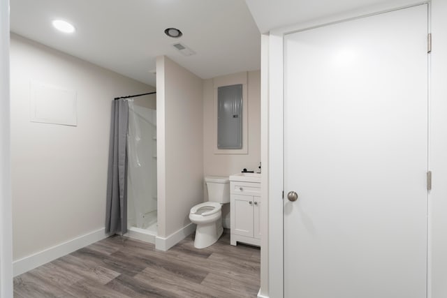 bathroom with a shower with shower curtain, toilet, vanity, and hardwood / wood-style floors