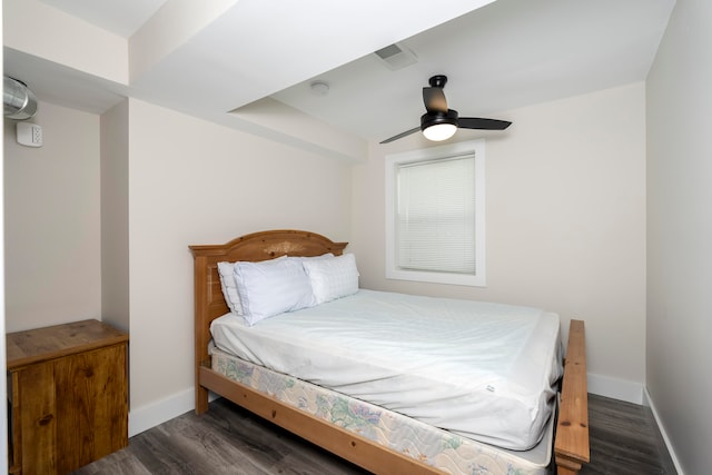 bedroom with dark hardwood / wood-style flooring and ceiling fan