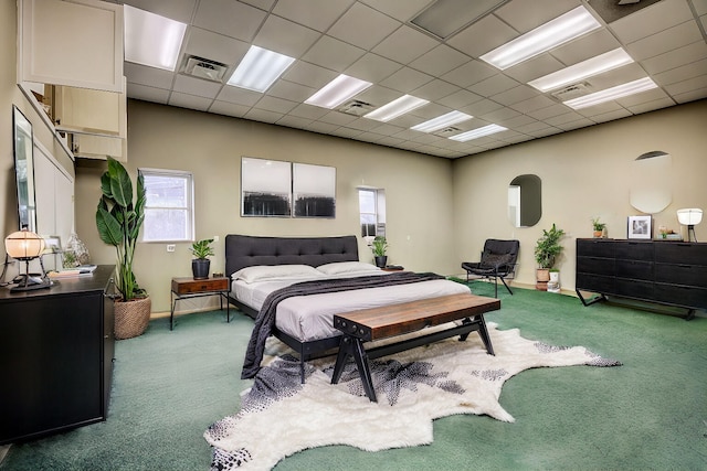 carpeted bedroom featuring a paneled ceiling