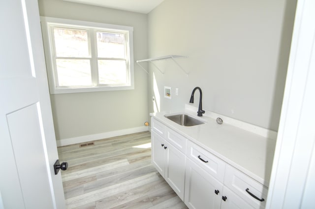 465 Cedar Hill Dr, Williamstown, KY 41097 - laundry area with washer hookup, light wood-style flooring, baseboards, and cabinet space