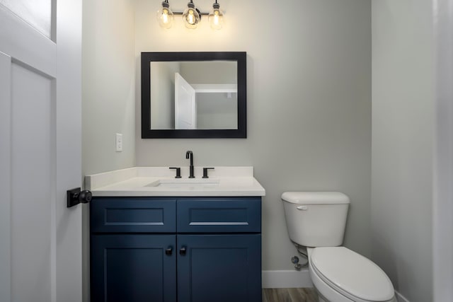 465 Cedar Hill Dr, Williamstown, KY 41097 - bathroom with toilet, vanity, baseboards, and wood finished floors