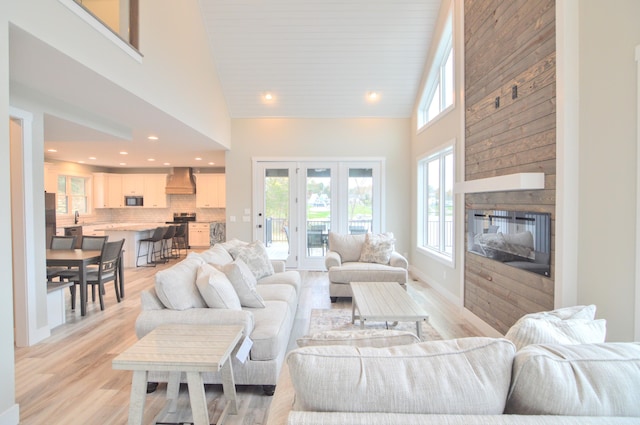 465 Cedar Hill Dr, Williamstown, KY 41097 - living room featuring a towering ceiling, light wood-style flooring, recessed lighting, and a glass covered fireplace