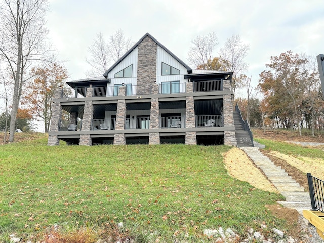 465 Cedar Hill Dr, Williamstown, KY 41097 - rear view of house with stone siding, a lawn, a balcony, board and batten siding, and stairway