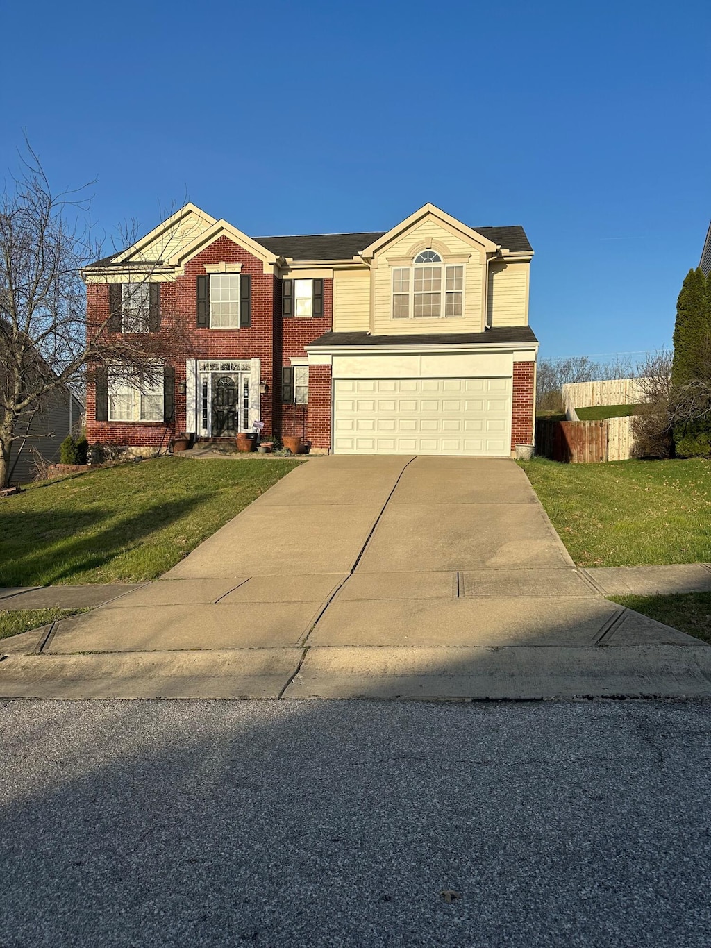 view of front of property with a front yard and a garage