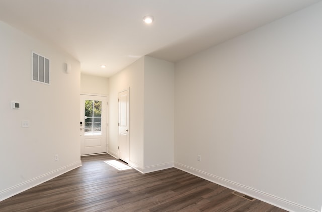 unfurnished room with dark hardwood / wood-style flooring