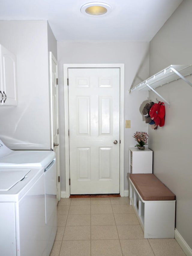 washroom featuring washing machine and clothes dryer and light tile floors