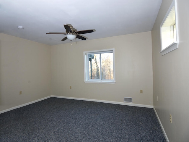 carpeted spare room with ceiling fan