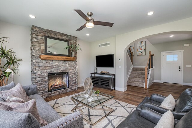 living room featuring hardwood / wood-style flooring, a fireplace, and ceiling fan